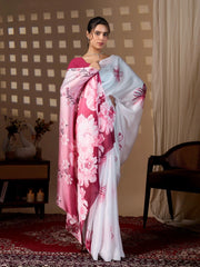 Woman wearing a floral saree in a room with a checkered wall and a chair.