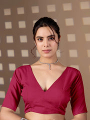 Woman wearing a red blouse with a neutral background
