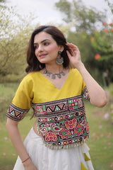 Graceful Ivory White Lehenga featuring Multicolor Ethnic Embroidery, Mustard Yellow Accents, and Flared Festive Silhouette