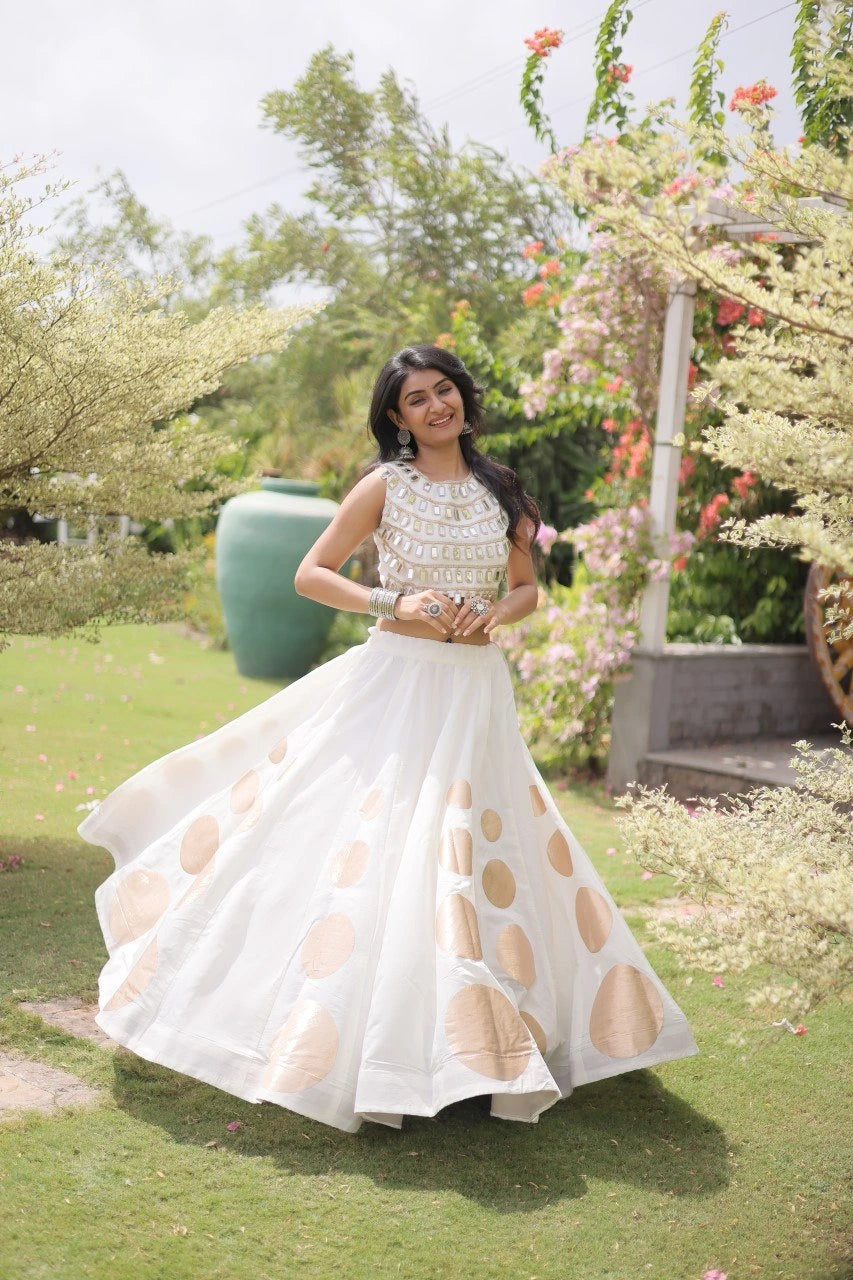Eye-catching golden circular foil patterns add a sophisticated and festive touch to the elegant white skirt.