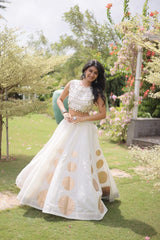 Stylish ethnic outfit combining a contemporary mirror work blouse with a flowing full-flare designer skirt.