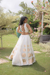 Premium white party wear lehenga designed with luxurious detailing and elegant traditional craftsmanship.