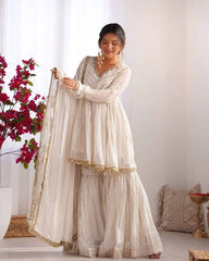 Woman in a traditional outfit with a white background and decorative elements.