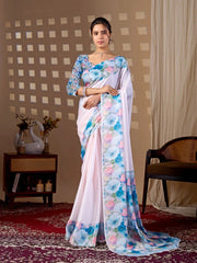 Woman wearing a white saree with floral patterns in a room setting