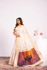 Woman wearing a white saree with a colorful design on a white background