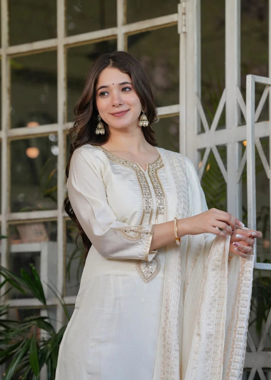 Elegant white Chanderi silk kurti featuring detailed thread embroidery and shimmering zari accents.