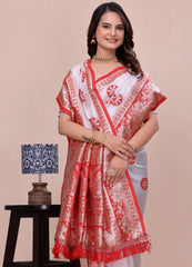 Woman wearing a red and white saree with a beige background
