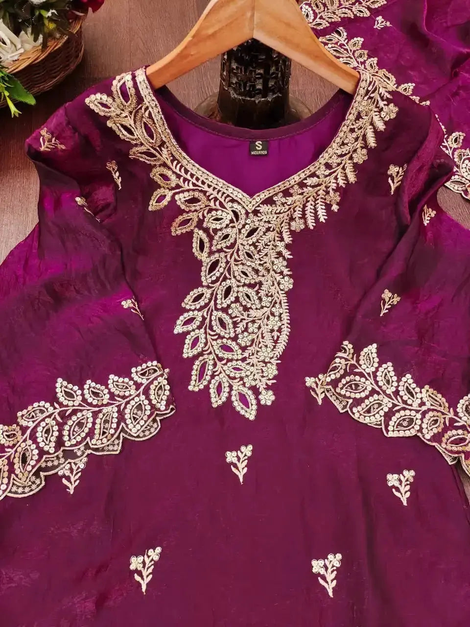 Close-up flat lay of gold sequin embroidery on Wine Sequins Embroidered Suit neckline