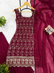 Maroon embroidered dress on a hanger with a close-up of fabric details.