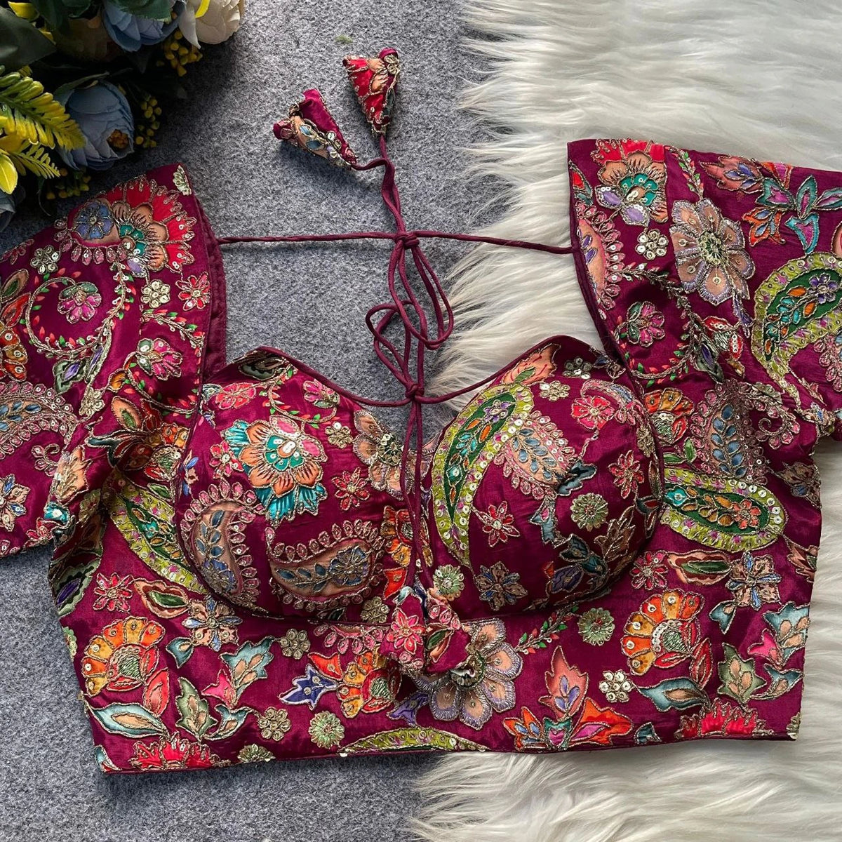 Colorful embroidered traditional outfit on a textured surface