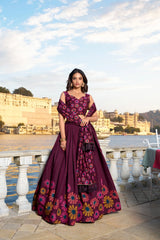 Woman in a purple floral dress standing outdoors with a scenic background