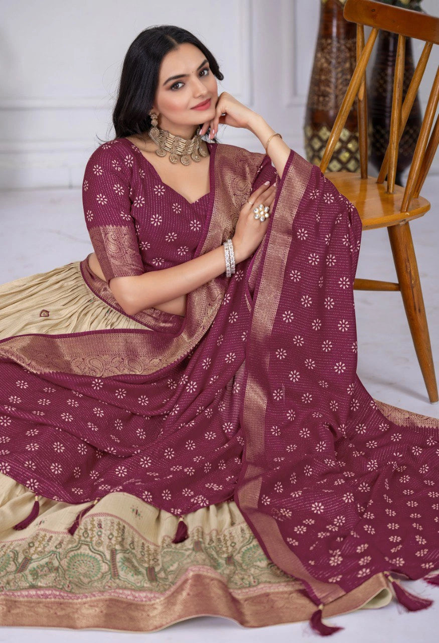 Woman wearing a maroon saree with a white blouse, sitting on a wooden chair.