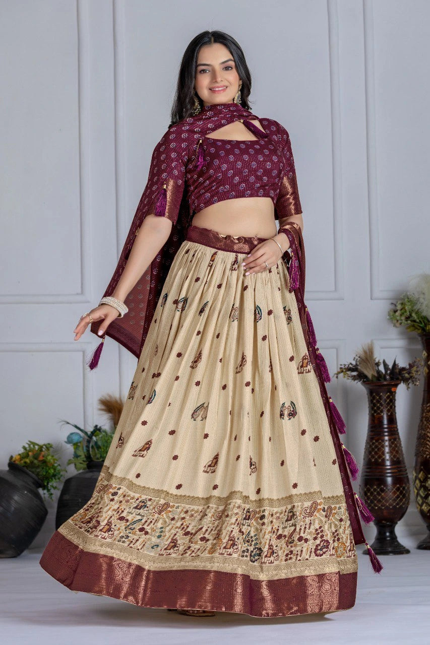 Woman wearing a traditional outfit with a maroon blouse and beige skirt against a white wall.
