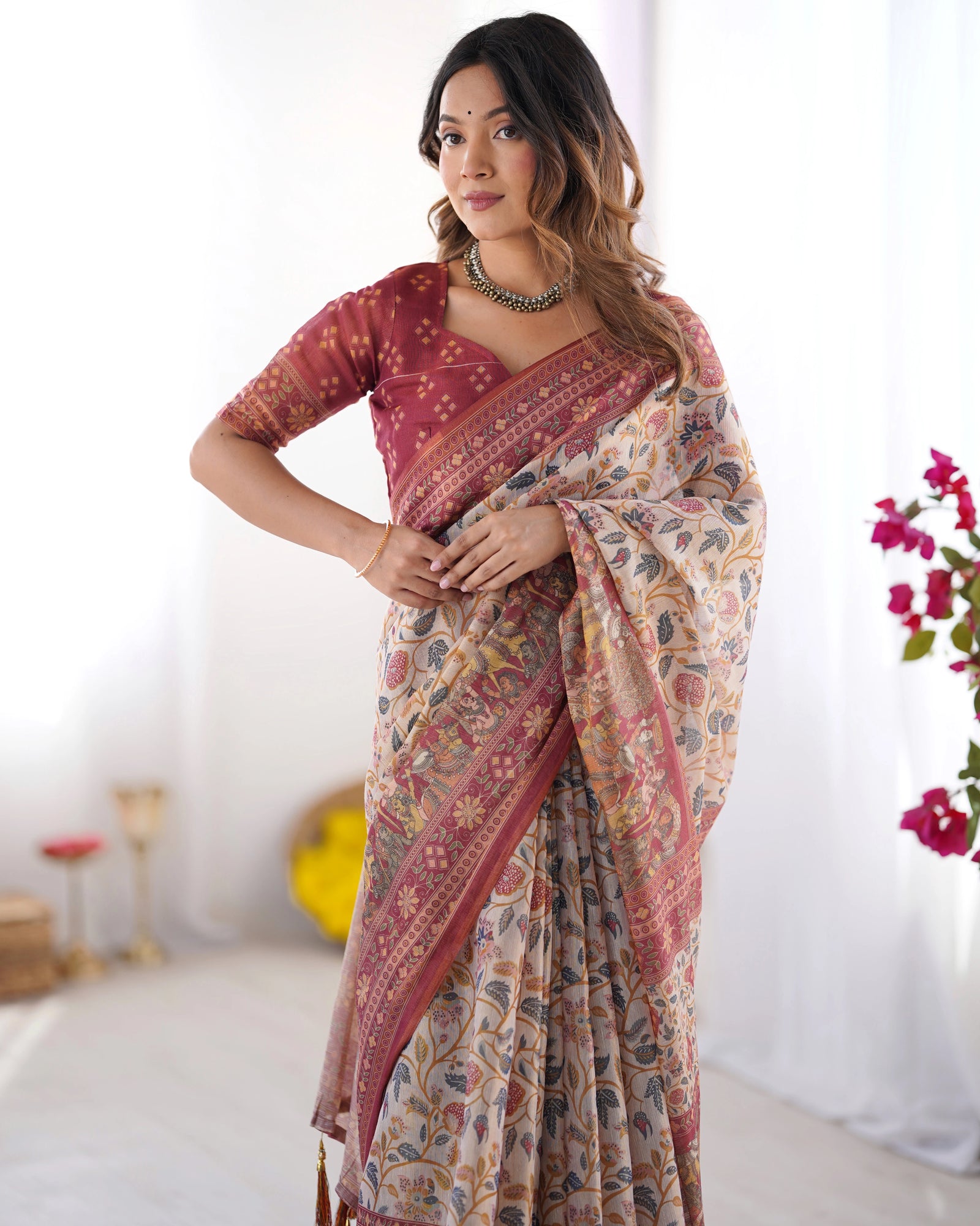 Woman wearing a patterned saree with a white background