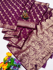 Purple saree with gold patterns, a small statue, and flowers on a white background