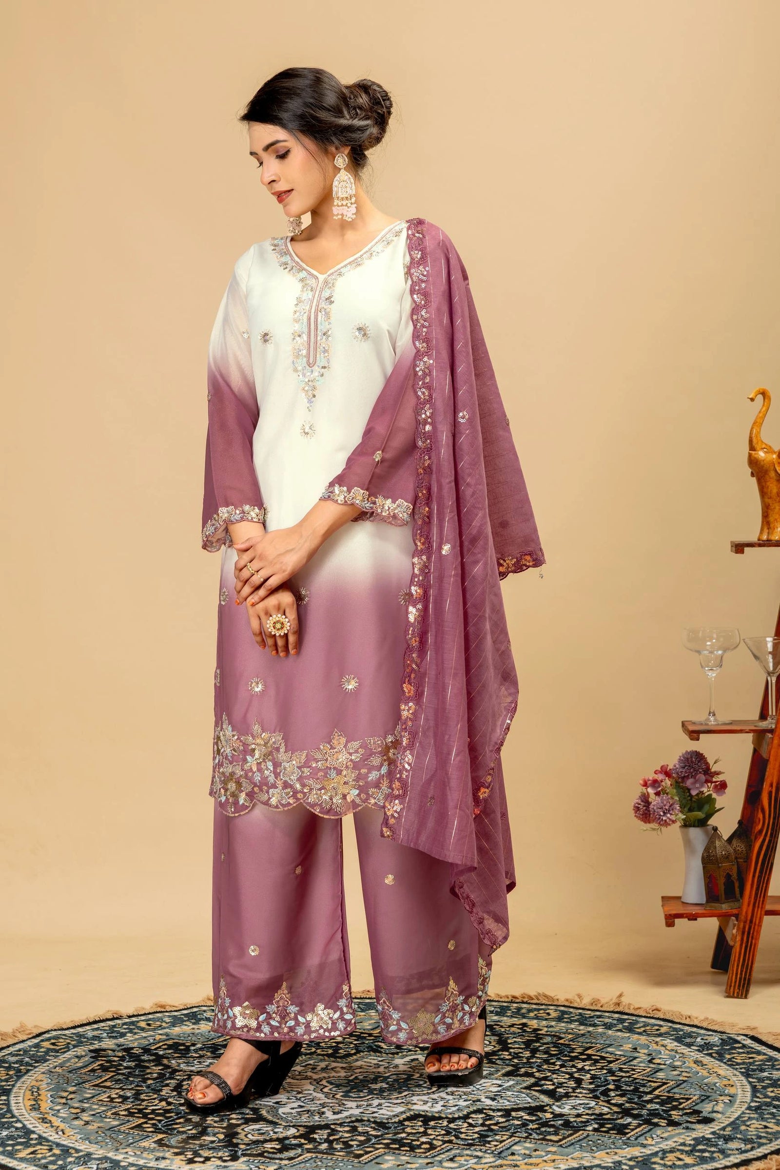 Woman wearing a traditional outfit with a purple dupatta and white blouse on a beige background