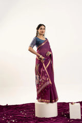 Woman wearing a purple saree with a white background