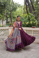 Woman in a traditional outfit with a colorful dupatta standing outdoors.