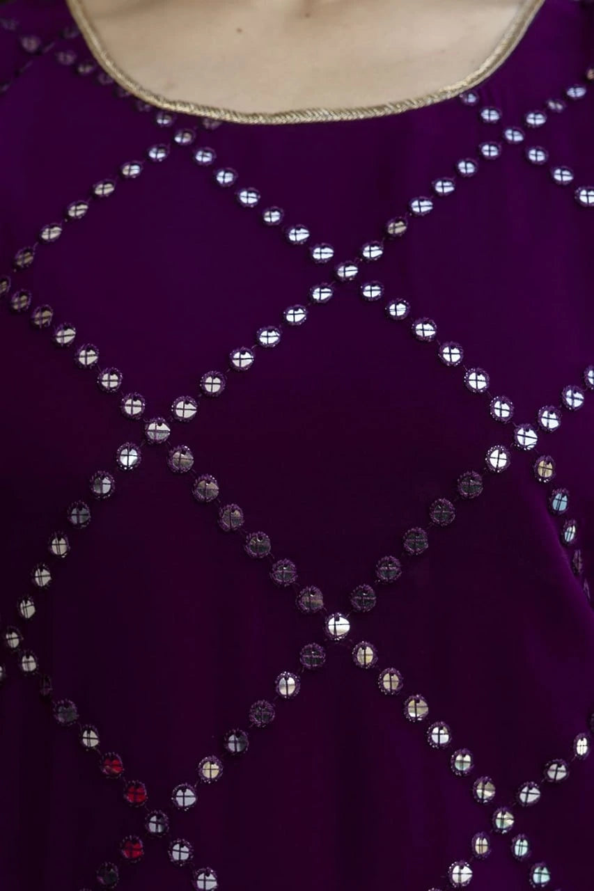 Close-up of a purple garment with silver bead detailing
