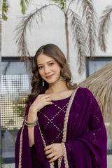 Woman in a purple traditional outfit with gold details outdoors.