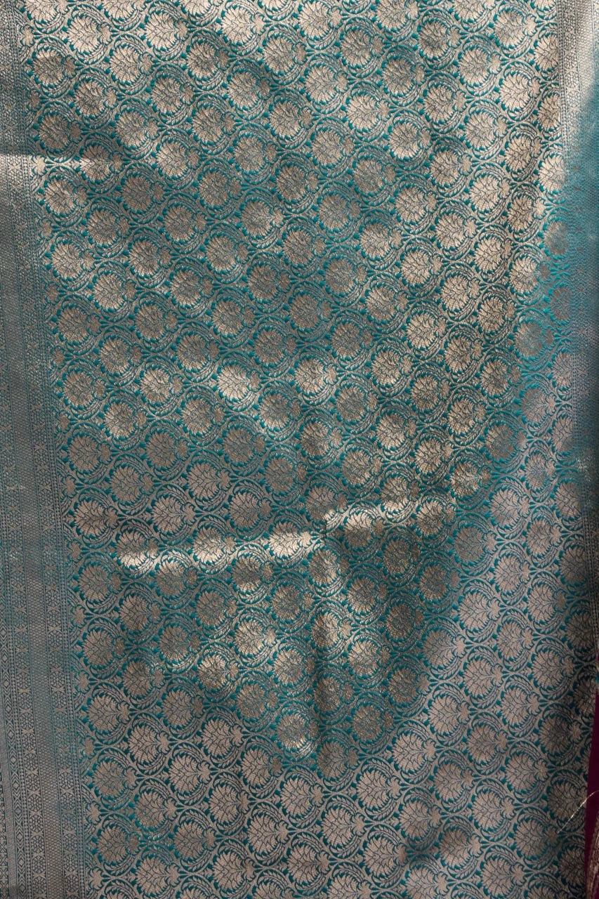 Teal fabric with silver circular patterns