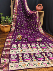 Purple saree with intricate patterns on a wooden surface