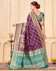Woman wearing a purple and green saree with a decorative background