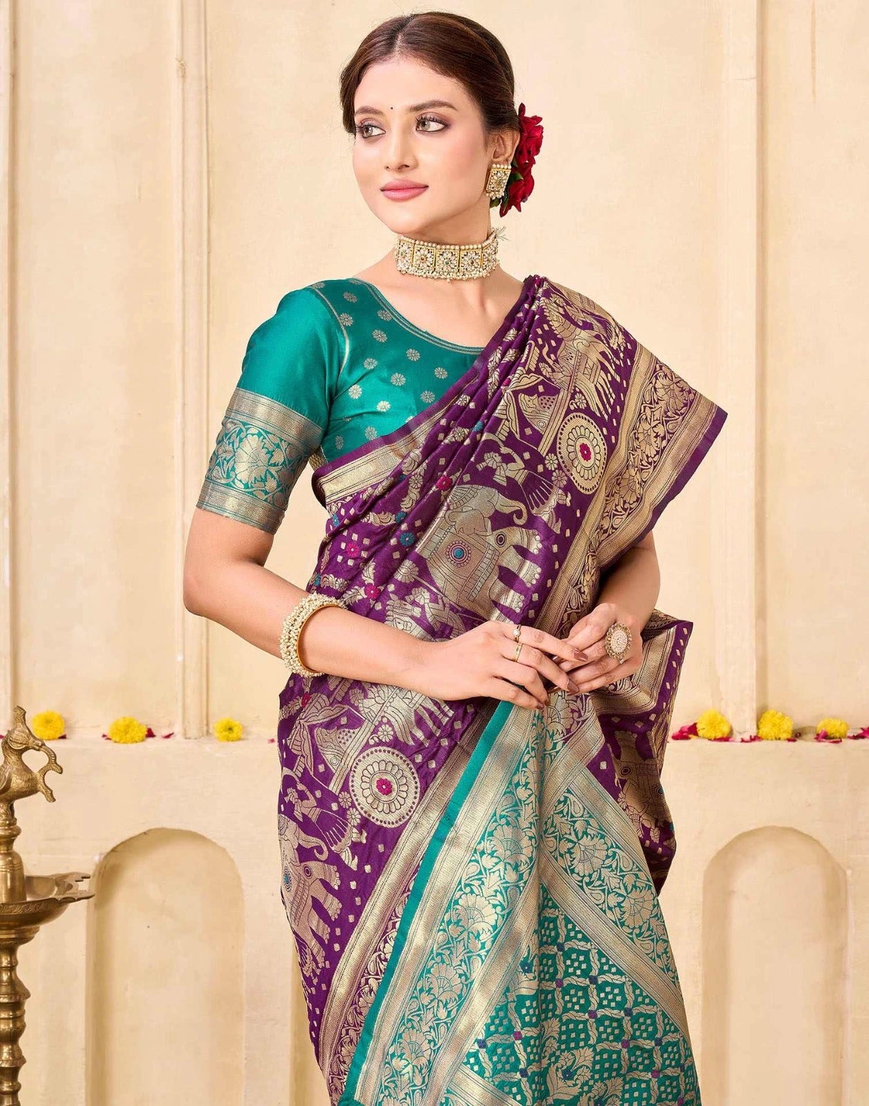 Woman wearing a purple and green saree with a decorative background