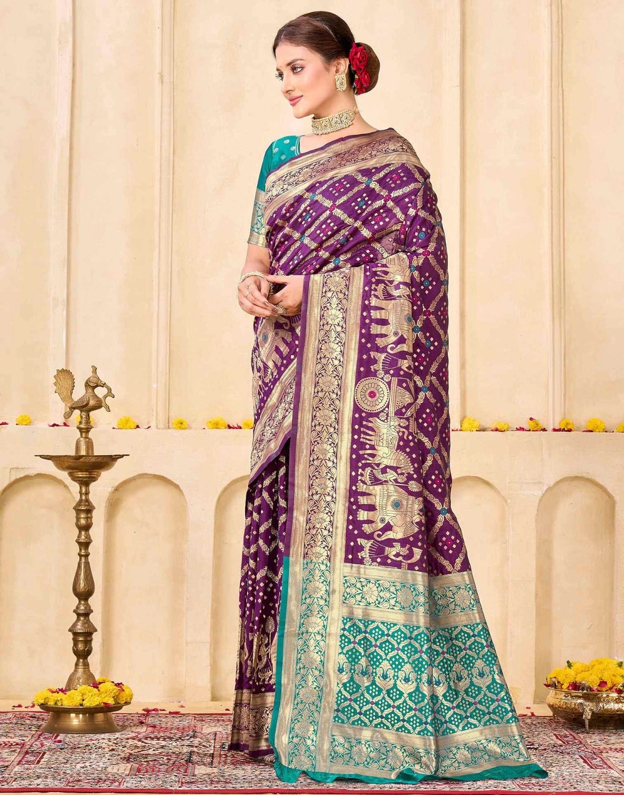 Woman wearing a purple and green saree with a decorative background