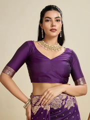Woman wearing a purple traditional outfit with gold embroidery on a beige background