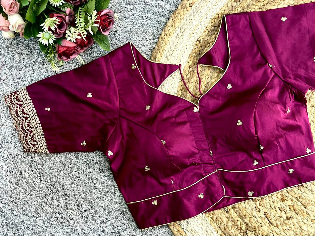 Purple saree with intricate designs on a textured surface