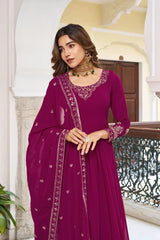 A close-up shot focusing on the bodice and jewelry. The woman is looking away with a soft expression, showcasing the detailed gold threadwork on the neckline and the shimmering sequined border of the magenta dupatta.