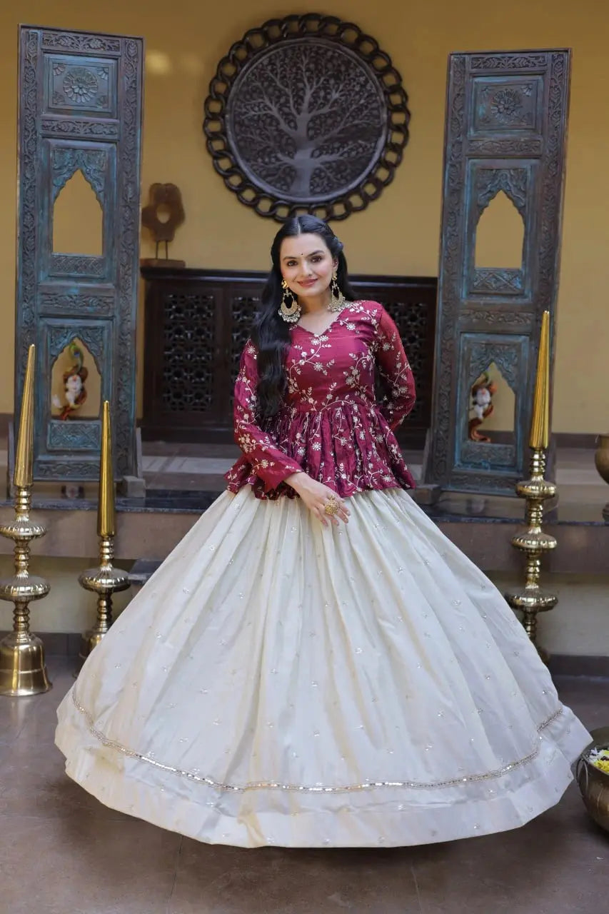 Woman in a red and white traditional outfit standing in a decorated room with blue wooden panels and gold candle holders.
