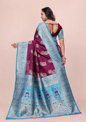 Woman wearing a purple and blue saree with a pink background