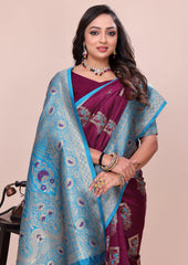Woman wearing a traditional maroon saree with a blue border against a beige background