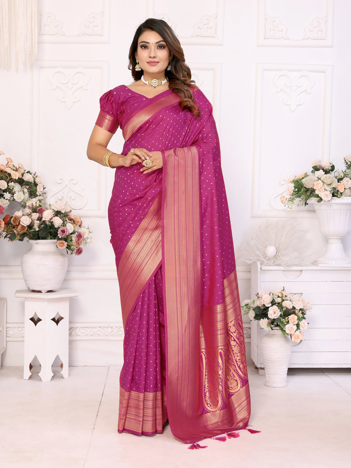 Woman wearing a pink saree with a white background