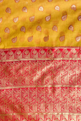 Traditional yellow and red fabric with intricate patterns