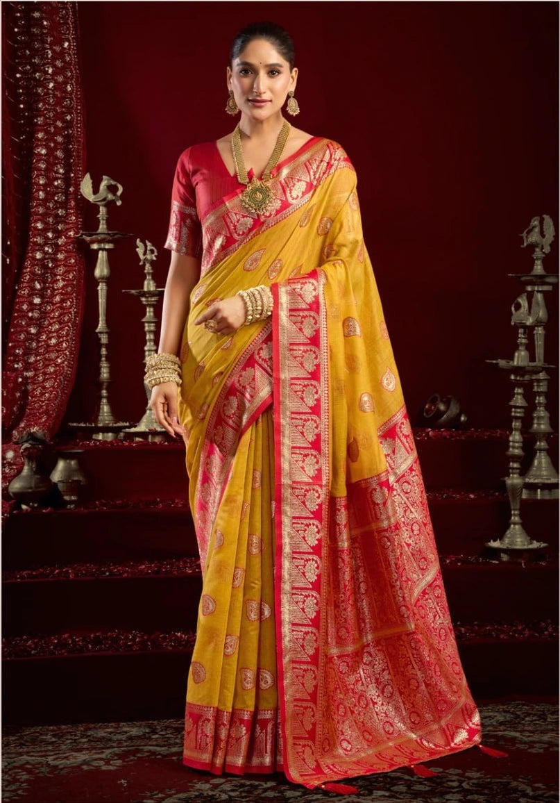Woman wearing a yellow and pink saree with a traditional setting