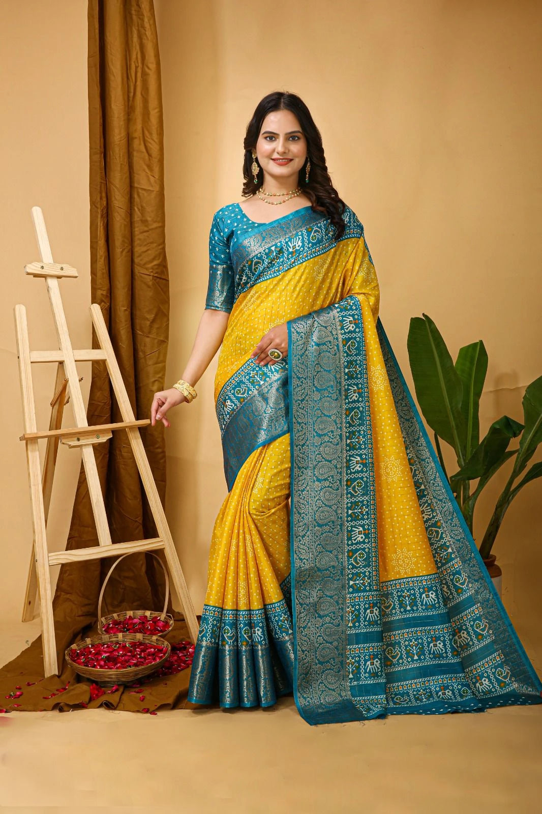Woman wearing a yellow and blue saree with a decorative background