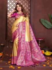 Woman wearing a traditional yellow and pink saree with intricate patterns against a decorative background.