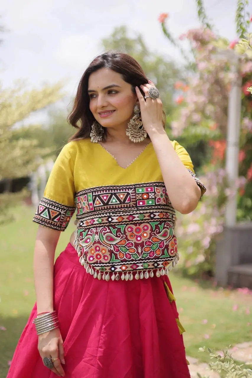 Designer Hot Pink Lehenga Set featuring Mustard Yellow Embroidered Blouse, Multicolor Artisan Motifs, and Contrast Border