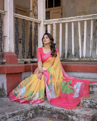 Woman in a yellow and pink saree sitting on steps with a dilapidated building in the background