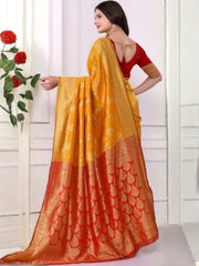 Woman wearing a yellow and orange saree with a white background