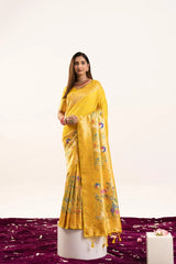 Woman wearing a yellow saree with a floral pattern on a white background