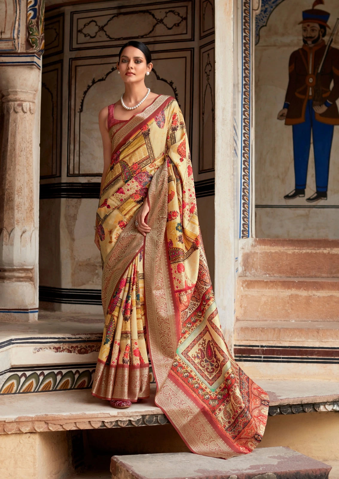Woman in a traditional saree standing in an ornate indoor setting