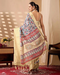 Traditional cream saree with intricate multicolor artwork and luxurious gold borders, styled with classic accessories in an indoor setting.