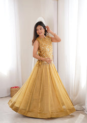 Woman wearing a yellow traditional outfit with a white curtain background