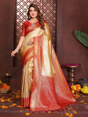 Woman wearing a red and beige saree with floral decorations on a brown background