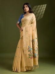Woman wearing a beige saree with floral patterns on a green background