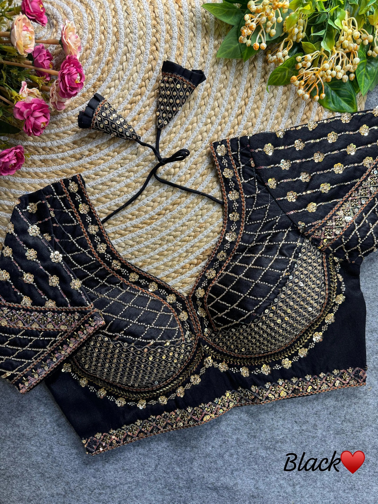 Black blouse featuring intricate sequence and codding thread work on soft silk fabric.
